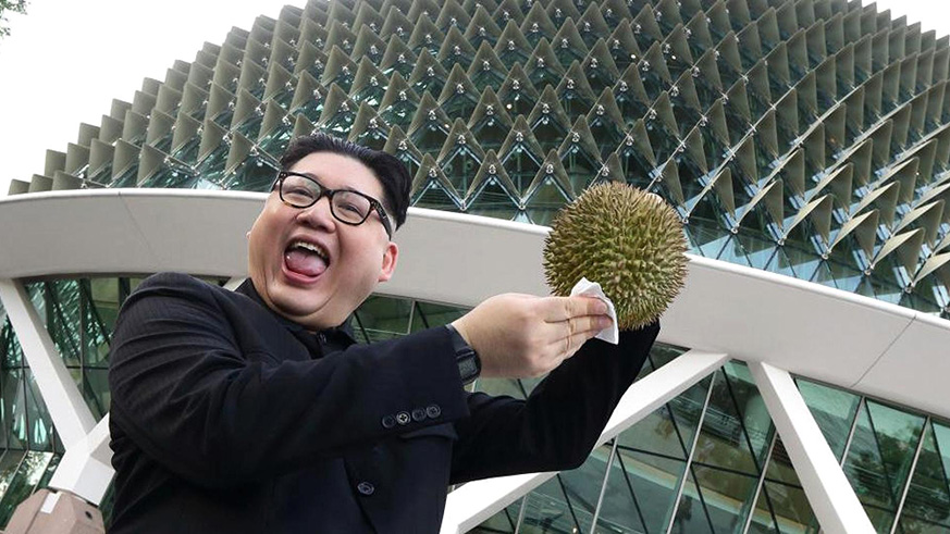A Kim Jong Un impersonator, Howard X, poses with a durian at the Esplanade on May 27, 2018 in Singapore. / Internet photo