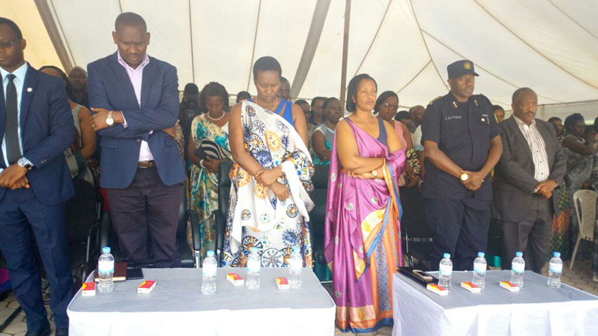 Officials observe a moment of silence during the reburial of 950 victims of the Genocide against the Tutsi, on Sunday. Michel Nkurunziza.