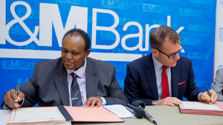 Robin Bairstow and Oumar Seydi during the signing of the deal at the Kigali Convention Centre.