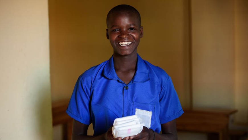 A Rwandan girl holds sanitary towels provided by ActionAid. Courtesy photo