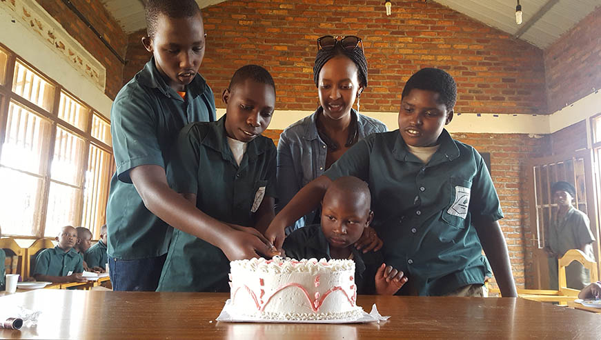 Some of the children cut cake with Higiro at one of their parties. 