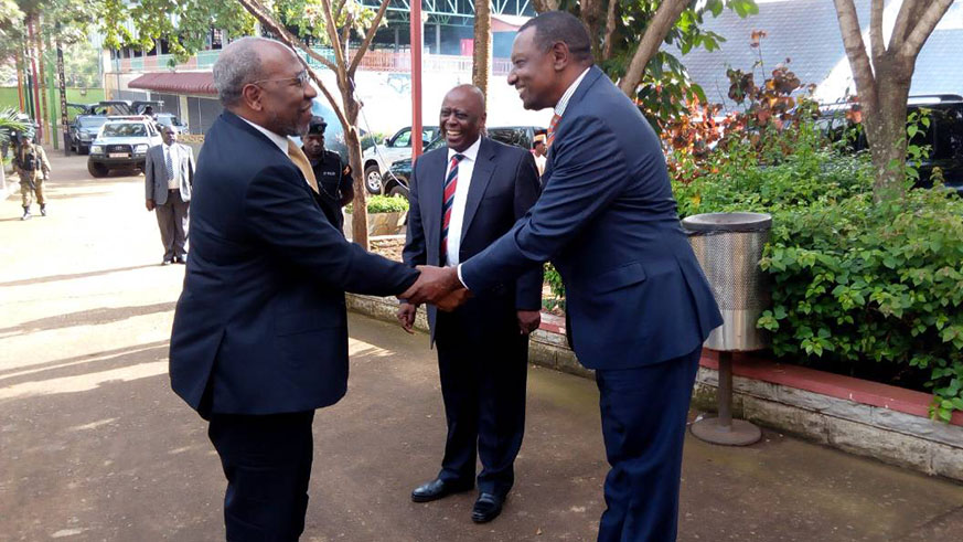 Rwanda's High Commissioner to Uganda Frank Mugambage welcomes Prime Minister Ruhakana Rugunda to the Africa Day celebrations in Kampala over the weekend. Courtesy 
