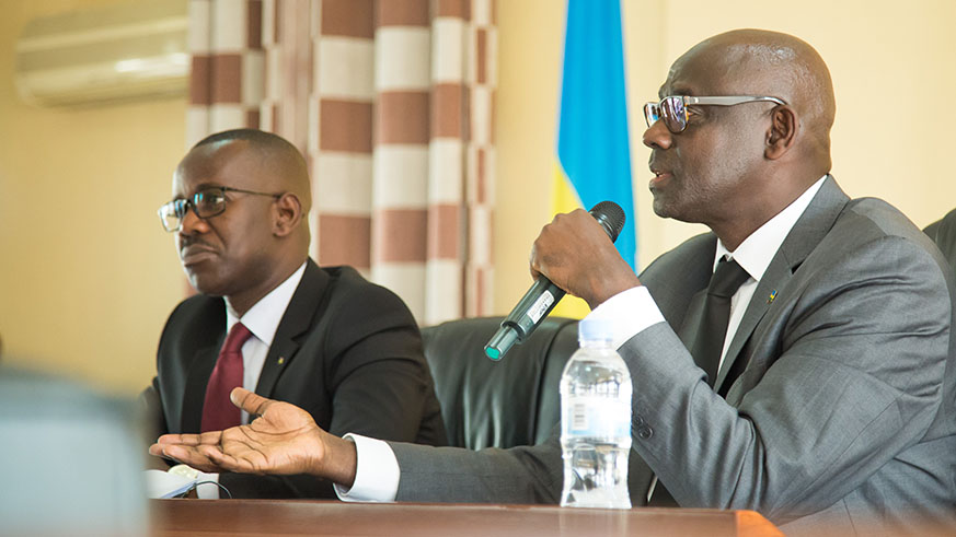 Minister for Justice Johnston Busingye (right) reassures citizens that the amended law on firearms will make it more difficult to acquire or sell a gun, during a news briefing yesterday at the Ministry of Justice. Looking on is EvodeUwizeyimana, the Minister of State in charge of Constitutional and Legal Affairs. Busingye said that there should be no cause for alarm amid the ongoing process to amend the law on firearms since the process of acquiring or selling a gun will be u201ctoo stringent. Nadege Imbabazi.