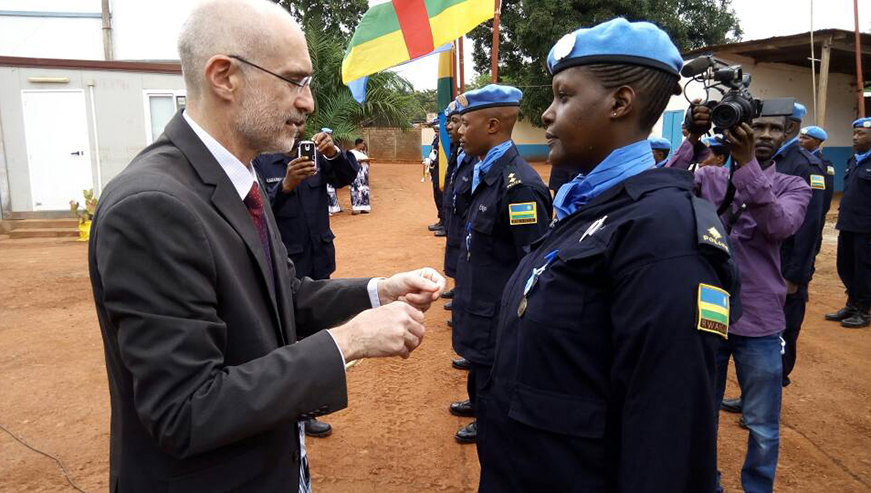 Deputy Representative of the UN-Secretary General in MUNUSCA, Kenneth Gruck, decorates one of the Rwandan Police officers. Courtesy.
