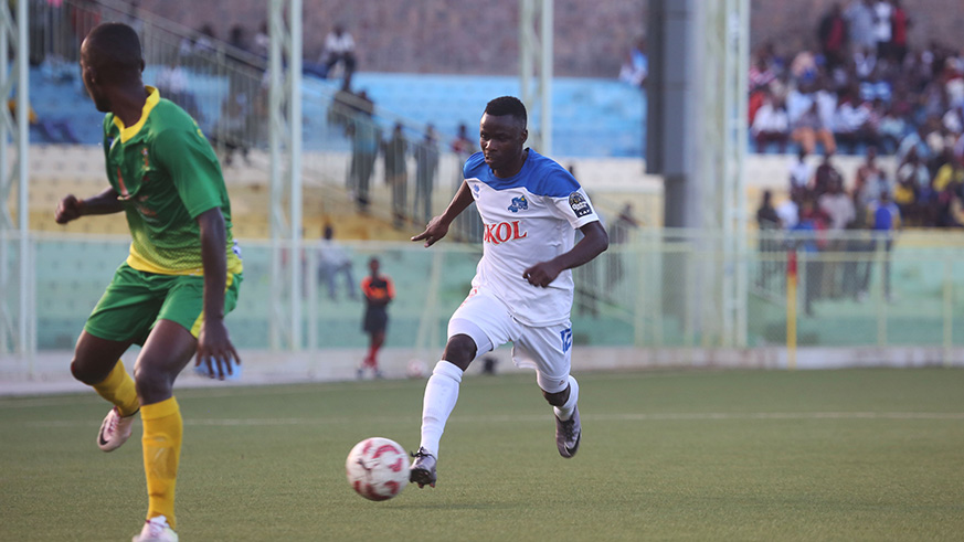Rayon Sports goal scorer Gilbert Mugisha trying to dribble past AS Kigali's left-back Niyomwungeri during the match at Kigali Stadium yesterday. / Sam Ngendahimana