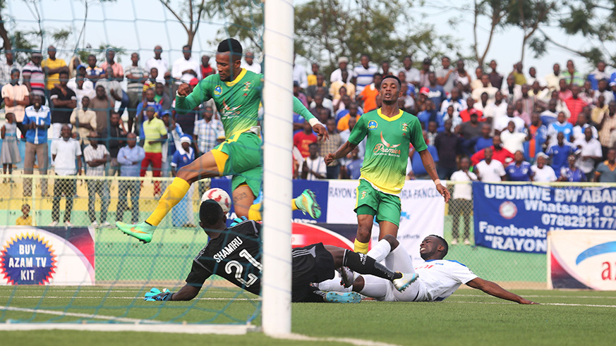 Rayon Sports's forward Christ Mbondi and AS Kigali defenders and goalkeeper battle for the ball during the match. / Sam Ngendahimana