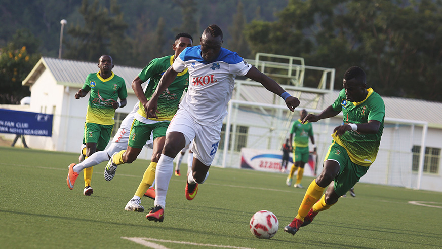 Striker Ismailla Dialla beats for the ball AS Kigali defenders during the match. / Sam Ngendahimana
