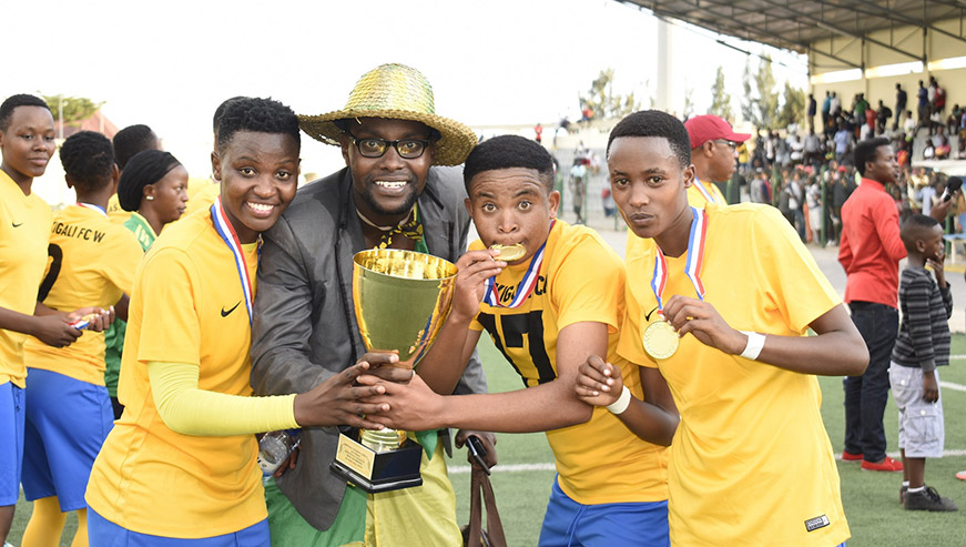 AS Kigali players and one team official showing off with medals and the trophy after the closely contested win yesterday at Umuganda Stadium. Courtsey