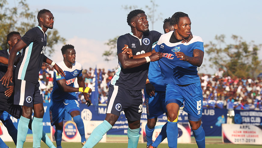 Police FC players battle for the ball with Rayon Sports player during 1-all draw at Kigali Stadium yesterday. Sam Ngendahimana.