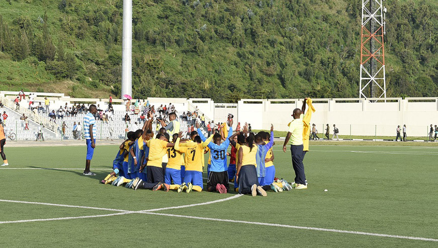 The City of Kigali-sponsored side say a team prayer after easing past Scandinavia to lift their tenth league title yesterday. Courtsey