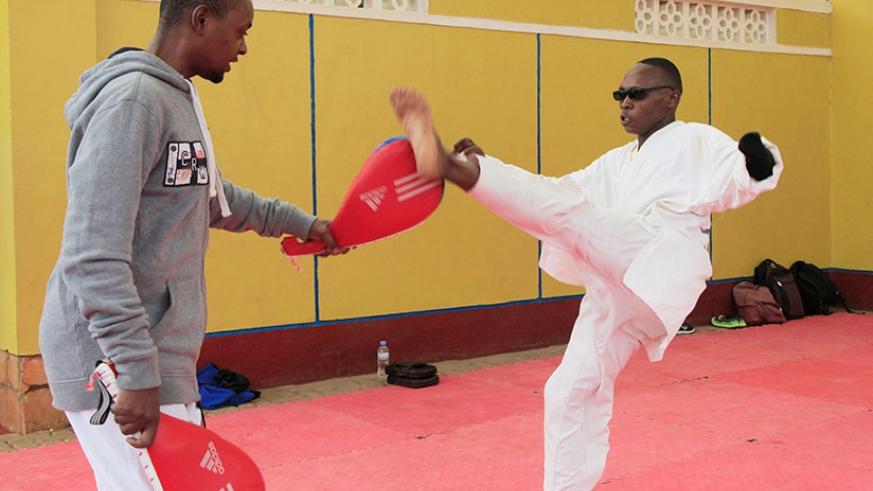 Jean Claude Niringiyimana during a practice session with his coach Allan Irene Bagire at Amahoro national stadium. File.
