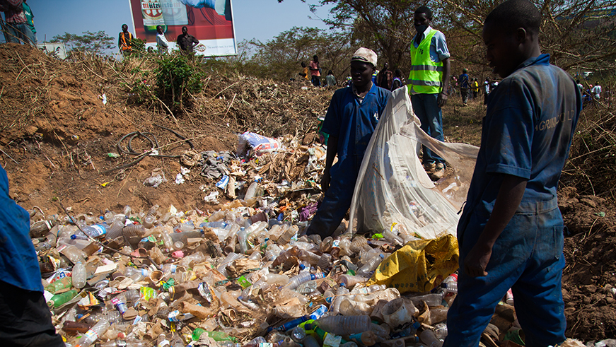 People sort plastic bottles at a dumping site. Nadege Imbabazi.