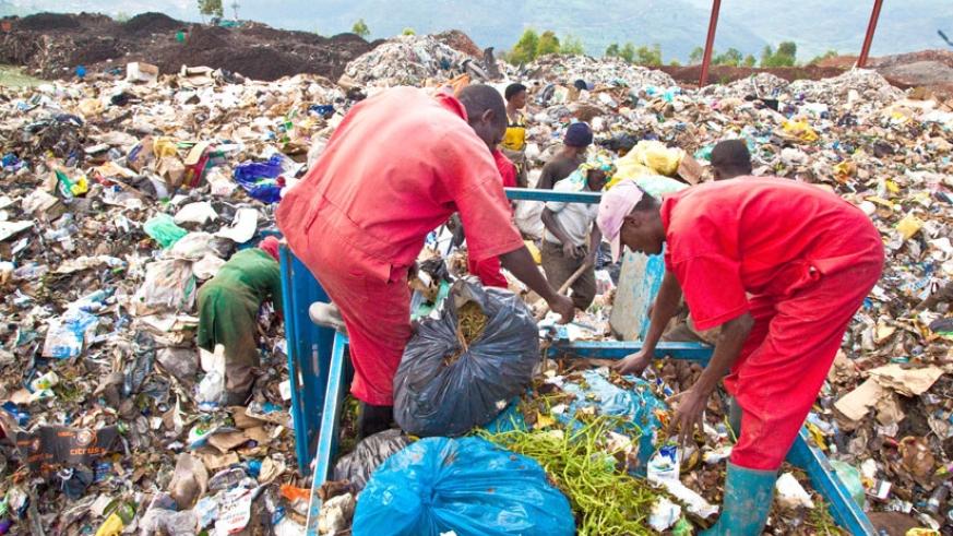 Workers at Nduba dumping site in Gasabo District offload Garbage. File.