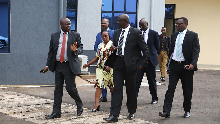 Col Jeannot Ruhunga,  Secretary General of Rwanda Investigation Bureau chats with Minister Busingye during the tour yesterday (Sam Ngendahimana)