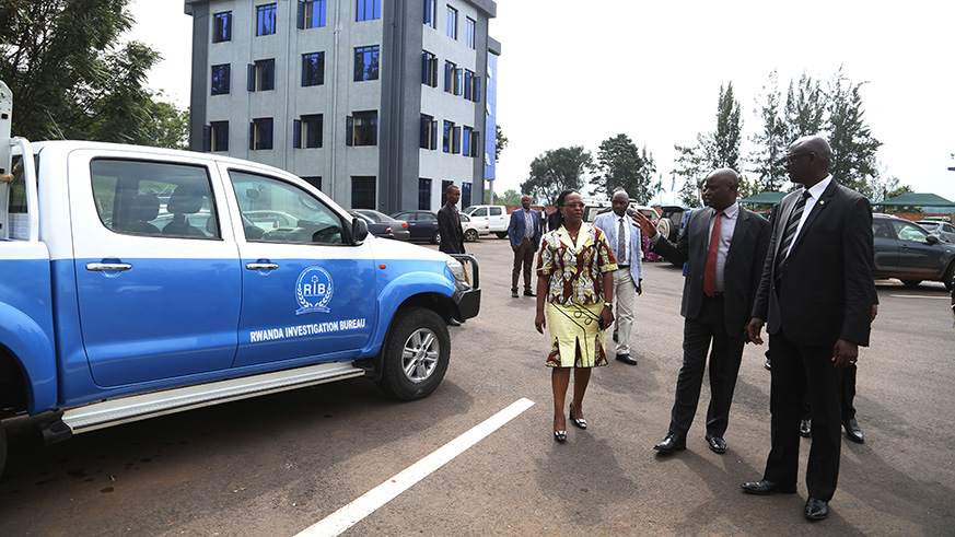 RIB Secretary General Col Jeannot Ruhunga shows the Minister some facilities during his visit yesterday (Sam Ngendahimana)