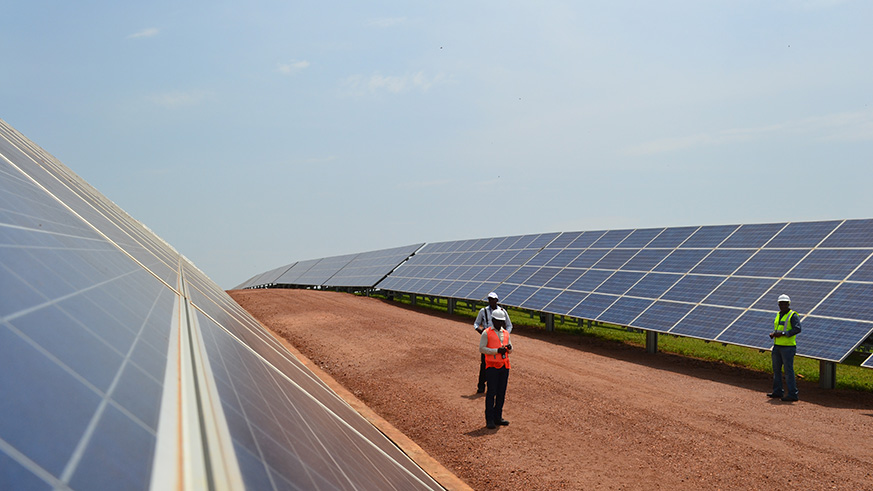 Workers inspect panels at an 8.5 megawatt solar power plant in Rwamagana District. Courtesy.