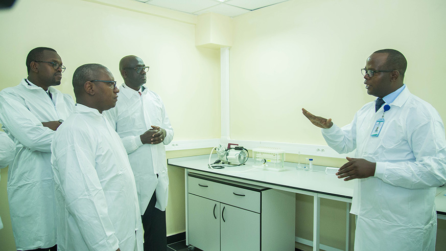 CIP Jean Pierre Samvura explains to Justice Minister Johnston Busingye, Minister of State for Public Health and Primary Healthcare Patrick Ndimubanzi (2nd left) and Prosecutor-General Jean Bosco Mutangana (left) during their tour of the new National Forensic Laboratory at its launch yesterday. The new facility will see Rwandans pay less for DNA tests to establish parentage for children or get proof for rape and other gender-based crimes among other forms of evidence. Nadege Imbabazi.