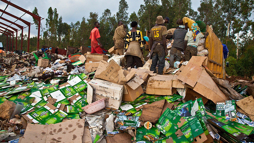 Workers sort garbage at Nduba Dump Site in Gasabo District. PAC has tasked the new City of Kigali Mayor, Marie-Chantal Rwakazina, and her team to urgently fix issues surrounding the landfill. File.