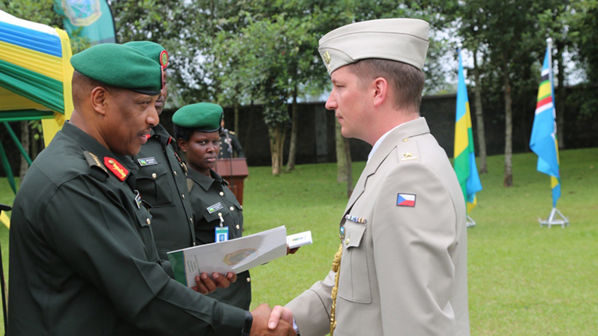 RDF Chief of Defence Staff  Gen. Patrick Nyamvumba awarding with the passed staff college certificate Maj. Ondrej Abony from Czech Republic. Regis Umurengezi