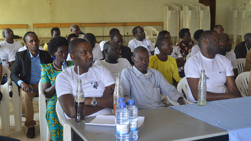 AB Bank staff with the famillies of the Genocide survivors in Gikomero.