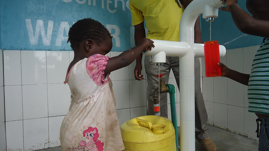 Children fetching water from water kiosk Children fetching water from water kiosk