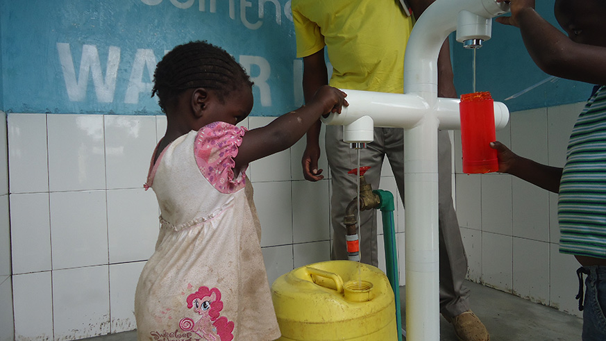 Children fetching water from water kiosk