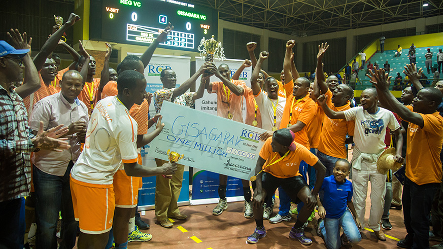 Gisagara Volleyball Club receives the trophy from the Senate president, Bernard Makuza, at Petit Stade Remera yesterday. Nadege Imbabazi.