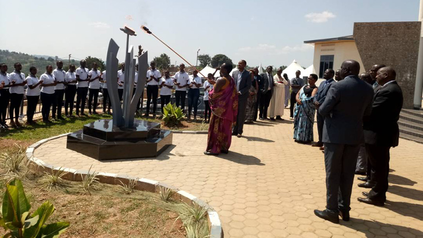 Julienne Uwacu, The minister for Sport and Culture lighting the flame of hope at the memorial on Saturday.