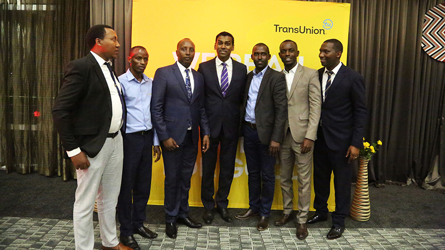 Lee Naik, the Chief Executive Officer of TransUnion Africa (C) poses with staff.
