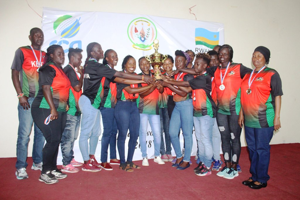 Kenya ladies' cricket team lift the trophy. 