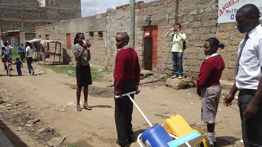 Students use jerry carry karts whichreduce the physical injury from constant lifting and carrying heavy loads of water on their heads. (Courtesy)