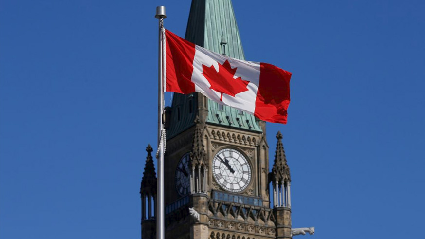 A Canadian flag flies in front of the Peace Tower on Parliament Hill in Ottawa, Ontario. / Internet photo