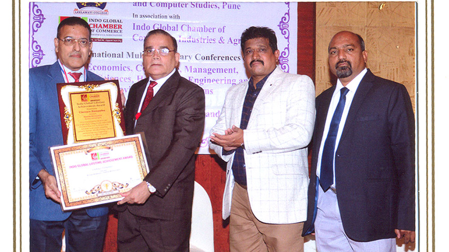 Clarence Fernandes (left) after receiving the Indo Global Lifetime Achievement Award for his contribution towards promoting investments and tourism into Rwanda. (Courtesy photo)