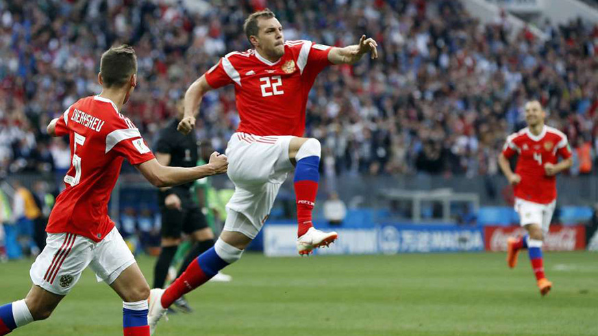 Artyom Dzyuba, center, celebrates after scoring Russia's third goal during the Group A opener between Russia and Saudi Arabia - which the hosts won 5-0. Net photo