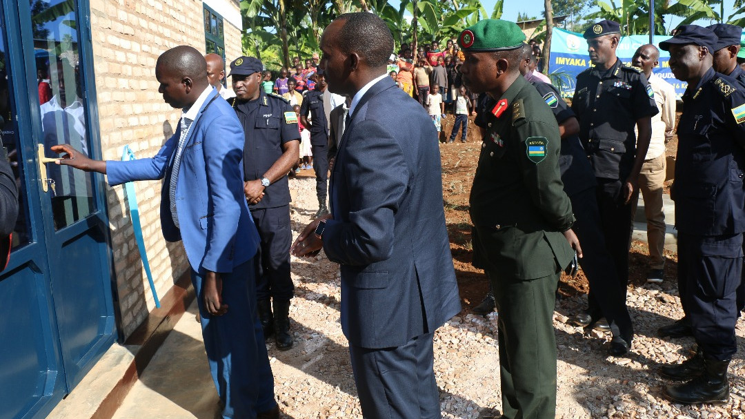 Morris Irivuzumugame, the village chief of Rwamugurusu, opening their newly constructed office as Governor Fred Mufulukye, senior police and military officers look on. / Courtesy
