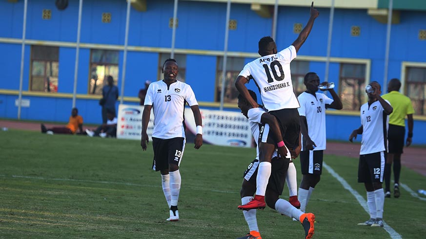 Djihad Bizimana carries brace scorer  Muhadjiri Hakizimana as they celebrated the 2-1 victory over Rayon Sports yesterday at Amahoro Stadium .Sam Ngendahimana.