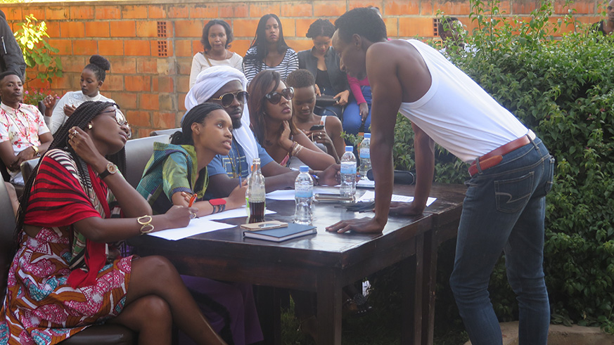 A model chats with the members of the pannel during the catwalks on Saturday2-Eddie Nsabimana