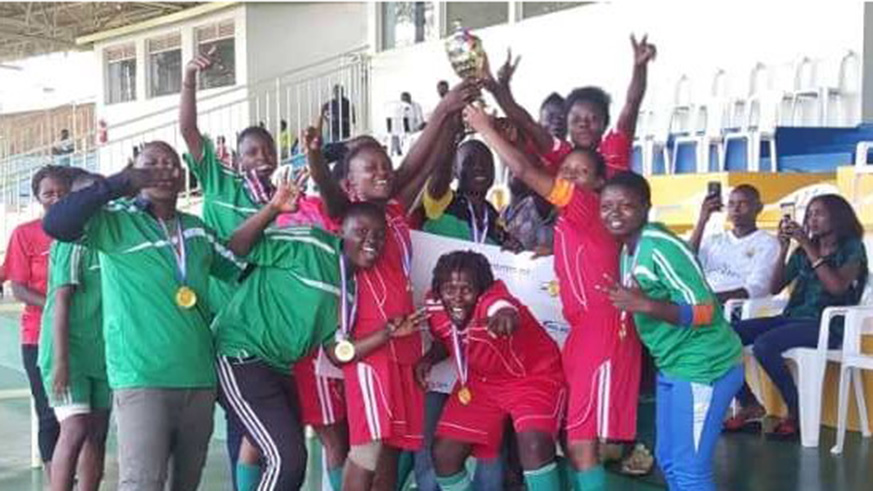 AS Kabuye Women Football Club celebrate with medals and the trophy at Kigali Stadium on Sunday after earning promotion to topflight league. / Courtesy
