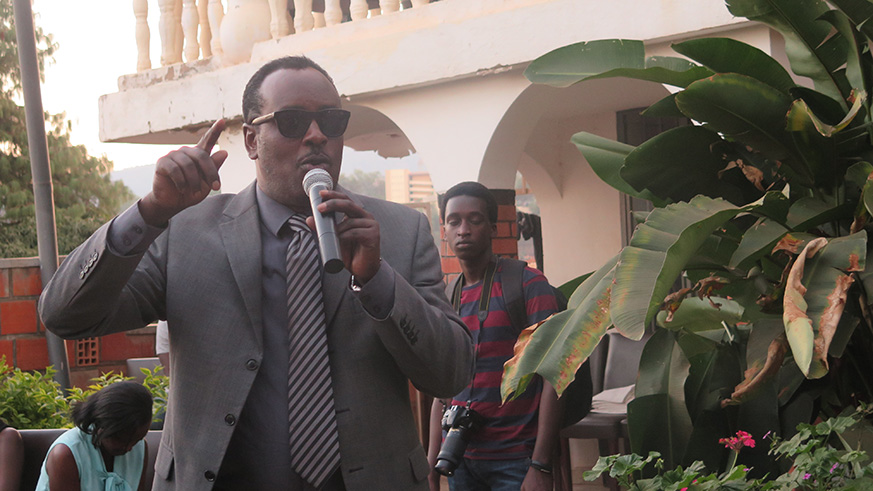 John Bunyeshuri, the founder and organizer of  Kigali Fashion Week, speaking to models - Eddie Nsabimana