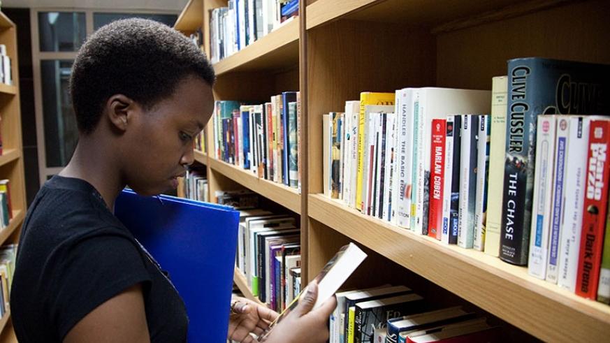 A student looks for a textbook at the public library in Kigali. File.