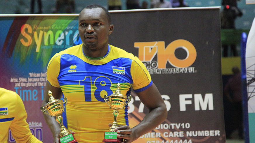 Rwanda National Basketball player Placide Sibomana holds two trophies after being crown the player of the tournament (Sam Ngendahimana)