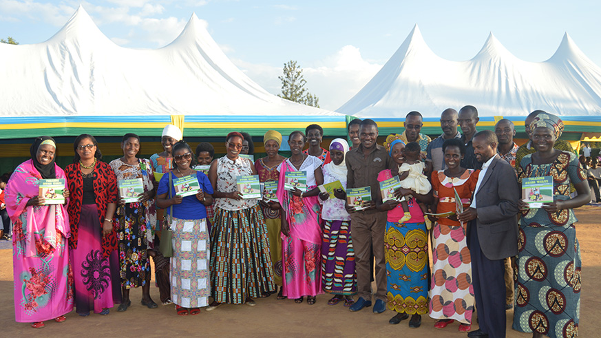 Dr Claudine Uwera Kanyamanza of the Rwanda National Commission for Children (centre, second row) and stakeholders in a group photo with members of â€˜Umugoroba wâ€™Ababyeyiâ€™ in Mayange Sector, Bugesera District yesterday. Courtesy.