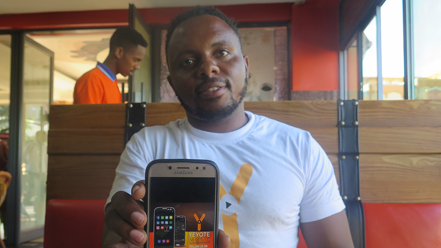 Kwizera explains how the application looks like on a mobile phone. Eddie Nsabimana.