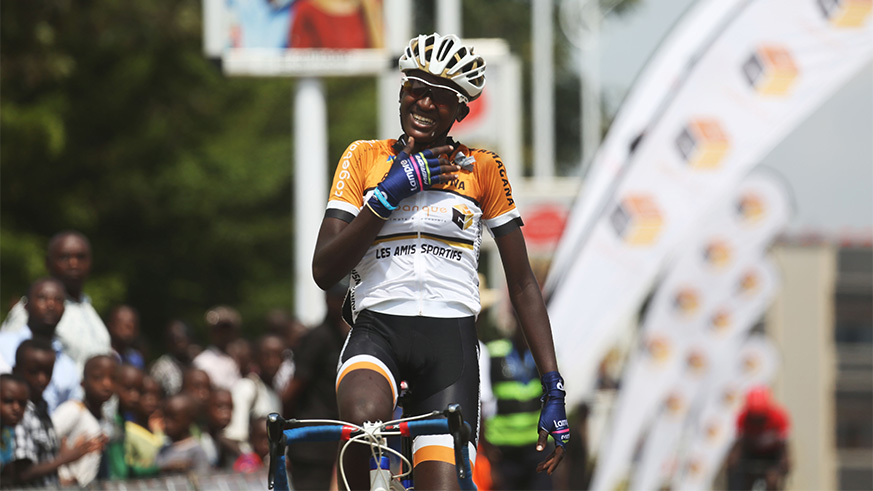 Les Amis Sportifs' Xaverine Nirere celebrates her solo finish as she crosses the finish line to win in the women category