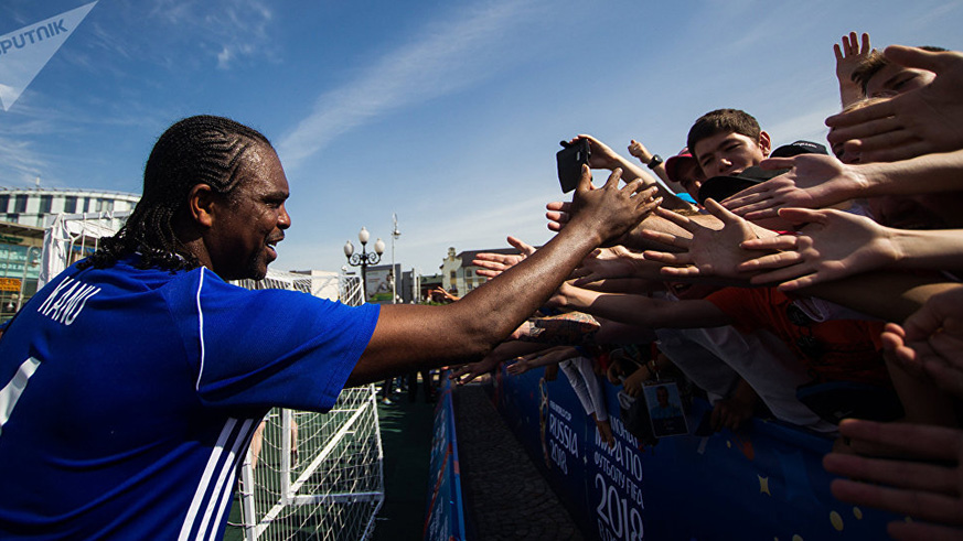 Nigerian legend Kanu greets fans outside a Russian stadium. 