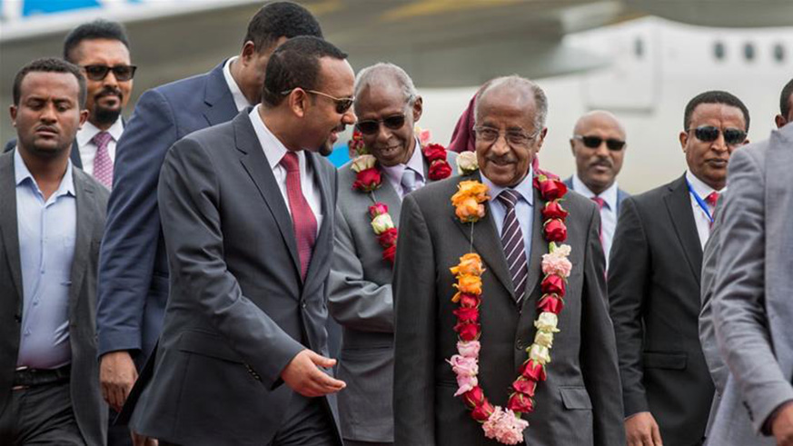 Eritrea's foreign minister (R) is welcomed by Ethiopia's prime minister (L) in Addis Ababa [Mulugeta Ayene/AP]