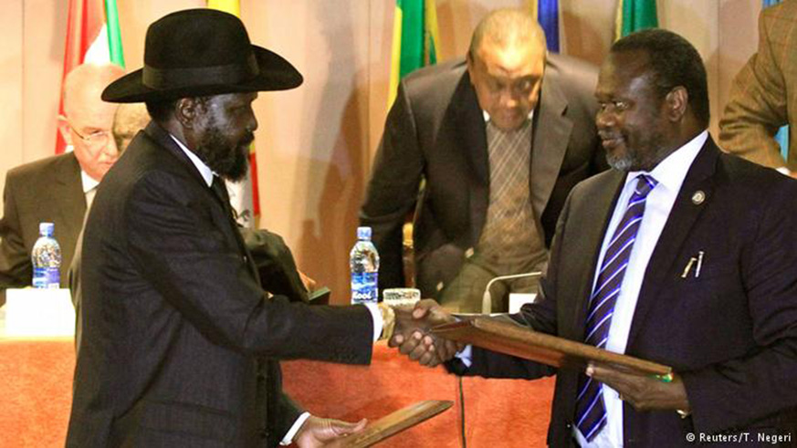 South Sudan President Salva Kiir and rebel leader Riek Machar shake hands.