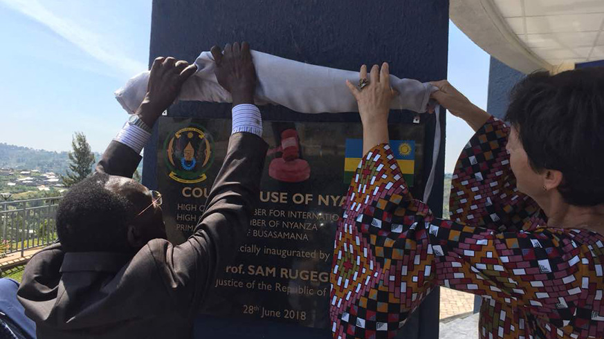 Rugege (L) and the Dutch ambassador to Rwanda FrÃ©dÃ©rique de Man unveil the plaque on the new High Court chambers in Nyanza. 