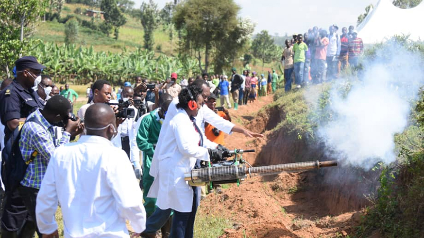 Defence minister Kabarebe uses spray against mosquitoes at the launch of the campaign in Kamonyi District. Courtesy.