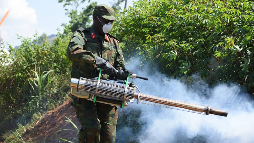 Defence minister Kabarebe uses spray against mosquitoes at the launch of the campaign in Kamonyi District. Courtesy.